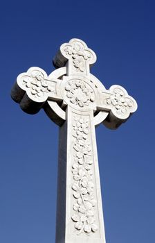 White Grave Stone Cross In Front Of Clear Blue Sky
