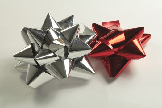 silver and red foil bows for attaching to a gift or present
