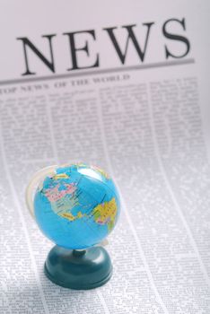 global news concept. small globe on a newspaper page. 