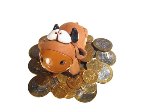 Ceramic bull or cow on the heap of coins