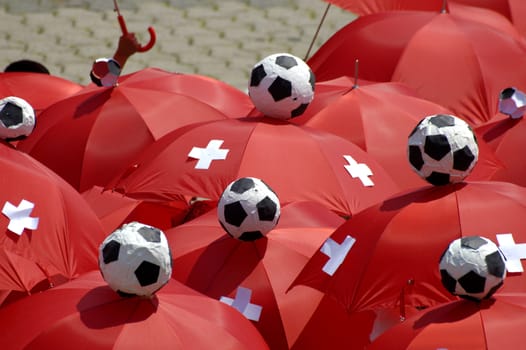 The red umbrellas of a group of Swiss football supporters during the football World Cup, 2006.