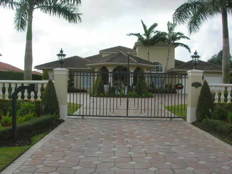   Mediterranean House with pavers, iron gate and landscaping        