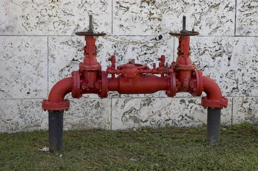 Red Water Valves with a keystone wall