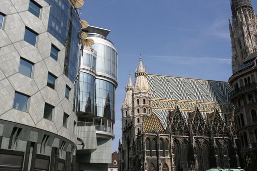 Contrast on Stephansplatz in Vienna (Austria) - new building of Haas Haus and old Gothic Cathedral (Stephansdom)