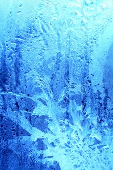 Nice blue pattern made from ice lying on window glass