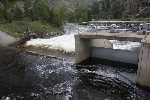 water diversion dam on the Cache la Poudre River in Colorado with a  springtime flow