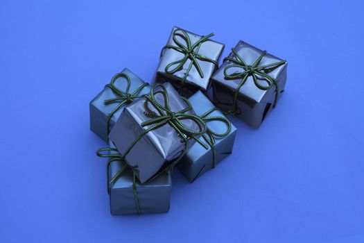 blue coloured boxed square presents fastened with bows