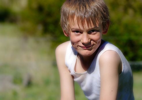 image of a boy in a singlet looking at the camera