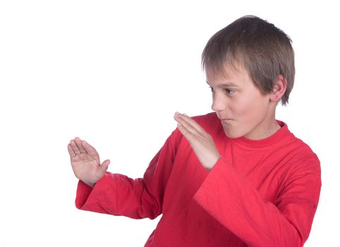 a boy on white background pretending to do martial arts