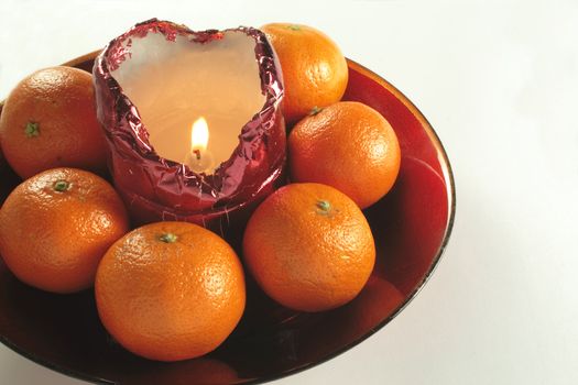 candle and fruit in a bowl for use as a table decoration