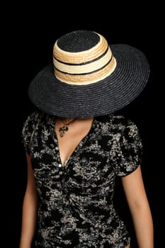 The young girl in a hat, on a black background