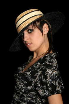 The young girl in a hat, on a black background