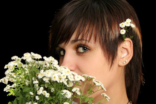 The young beautiful girl with flowers, isolated on a black background