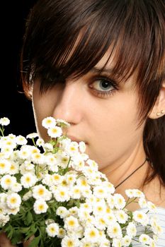 The young beautiful girl with flowers, isolated on a black background