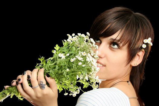 The young beautiful girl with flowers, isolated on a black background