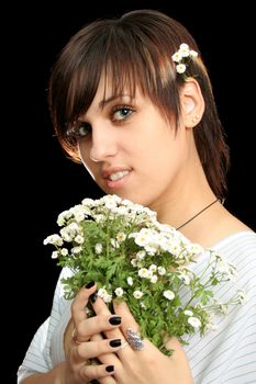 The young beautiful girl with flowers, isolated on a black background