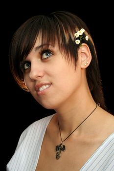 The young beautiful girl with flowers, isolated on a black background