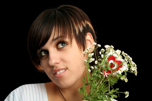 The young beautiful girl with flowers, isolated on a black background