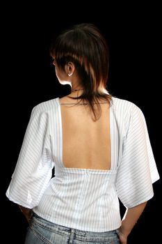 The young woman with the open back, isolated on black