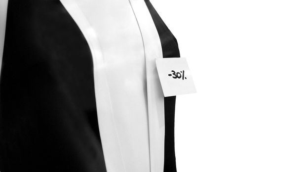 Female showroom dummy with sales reduction tag - selective focus on label - isolated - (16:9 ratio)