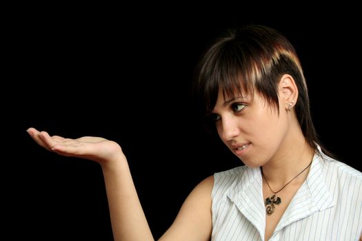 The young girl looks at something in a hand, is isolated on a black background