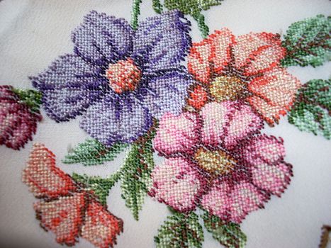 This is some embroidered flowers on a canvas. It’s a hand-made embroidery.