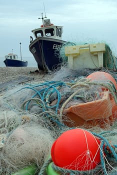 Photo in a harbor of fishing lines with boats in the background