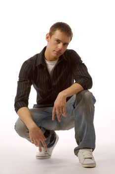 The beautiful young man posing in studio