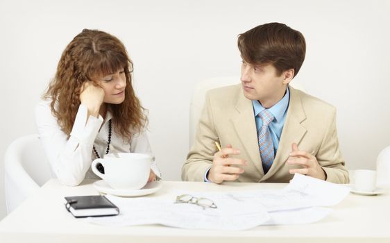 The woman has got tired and falls asleep on a workplace at office