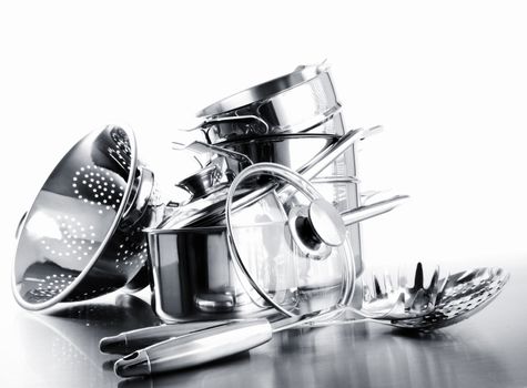 Pile of pots and pans against a white background