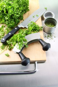 Fresh chopped parsley with cutting board on stainless steel