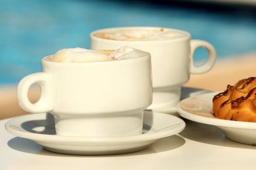 Coffee cups and cookies on the table