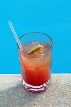 FRUIT COCKTAIL STANDS ON EDGE OF POOL