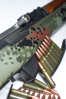 An old military rifle with stripper clips of ammunition