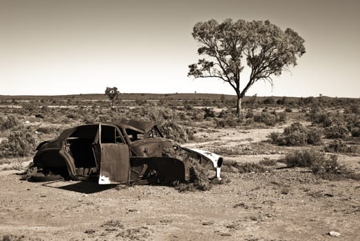 great image of an old car rusting away in the desert