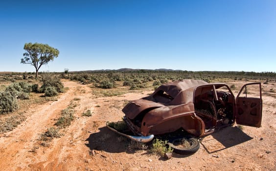 great image of an old car rusting away in the desert
