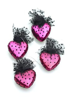 four pink and black hearts on white background