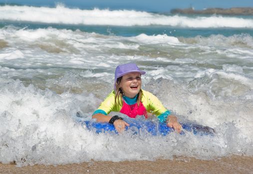 a girl in the waves at the beach