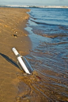 great image of a message in a bottle at the waters edge