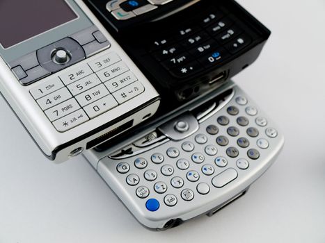 Stack Pile of Several Modern Mobile Phones PDA Cell Handheld Units Isolated on White Background