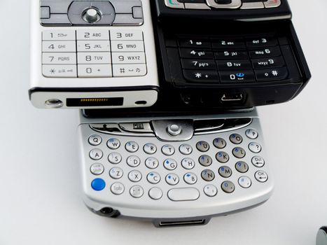 Stack Pile of Several Modern Mobile Phones PDA Cell Handheld Units Isolated on White Background