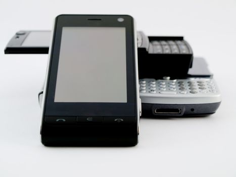 Stack Pile of Several Modern Mobile Phones PDA Cell Handheld Units Isolated on White Background