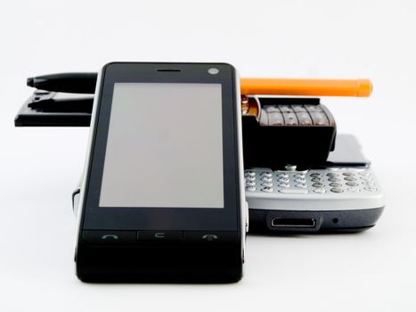 Stack Pile of Several Modern Mobile Phones PDA Cell Handheld Units with Biro Ballpoint Isolated on White Background