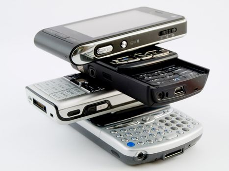 Stack Pile of Several Modern Mobile Phones PDA Cell Handheld Units Isolated on White Background
