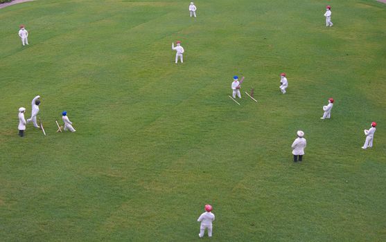 scale model of people playing a cricket match 