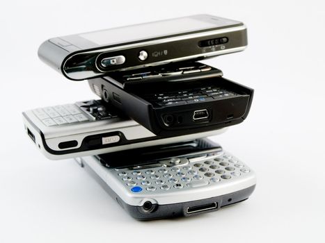 Stack Pile of Several Modern Mobile Phones PDA Cell Handheld Units Isolated on White Background