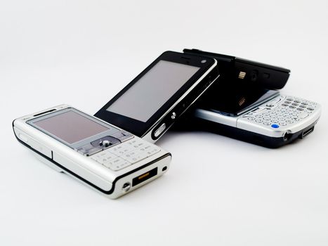 Stack Pile of Several Modern Mobile Phones PDA Cell Handheld Units Isolated on White Background