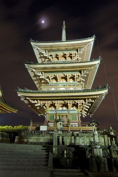 Kiyomizudera pagoda in Kyoto, Japan at moonlight and surrounding illumination