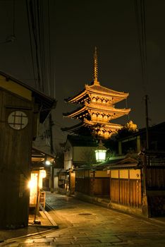 rural Kyoto streets at night in eastern part of the city with illuminated 3store pagoda background