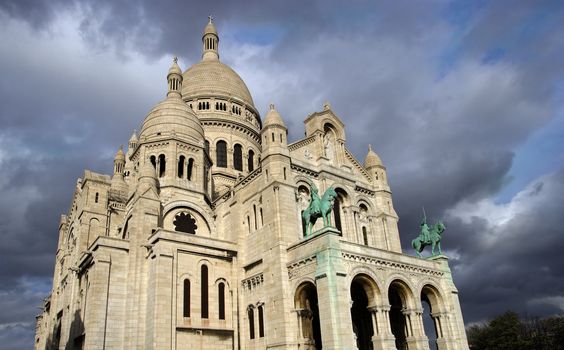 Sacre Coeur in Paris, France, as storm clouds gather.
